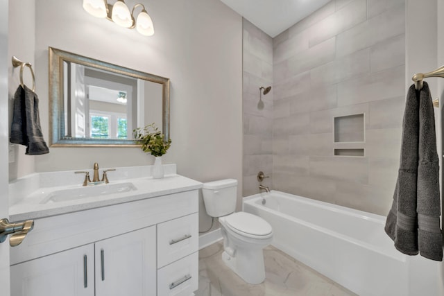 full bathroom with tiled shower / bath, vanity, and toilet