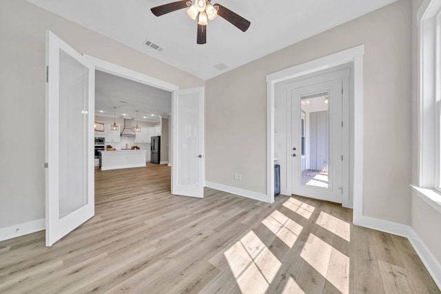 interior space with ceiling fan and light hardwood / wood-style floors