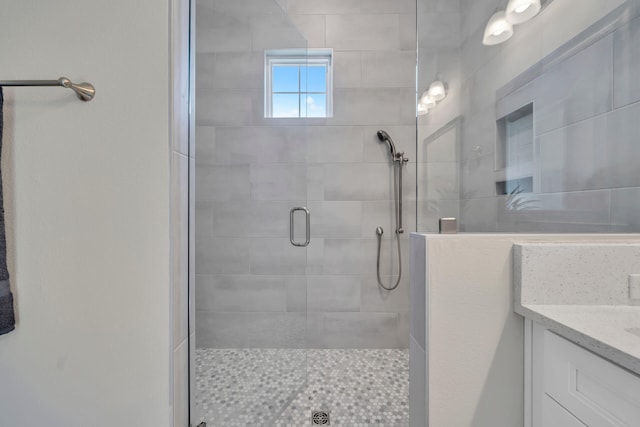 bathroom featuring a stall shower and vanity