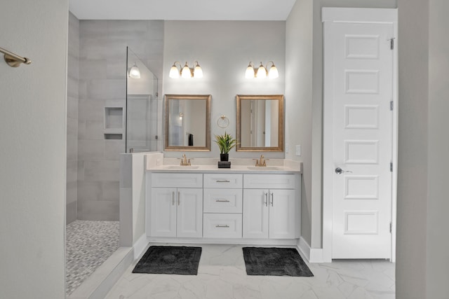 bathroom with marble finish floor, double vanity, a sink, and a walk in shower