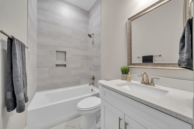 full bathroom featuring washtub / shower combination, marble finish floor, vanity, and toilet