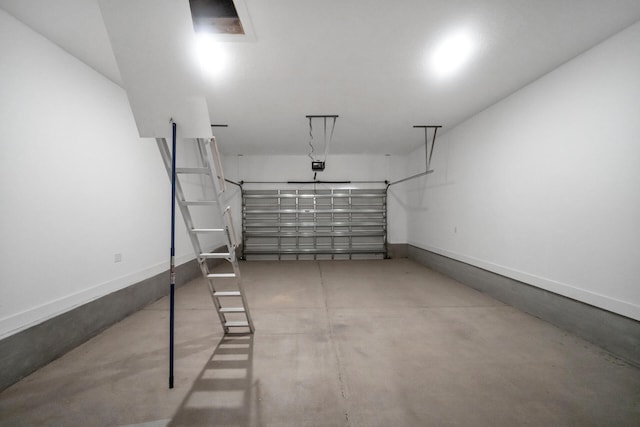 garage featuring baseboards and a garage door opener