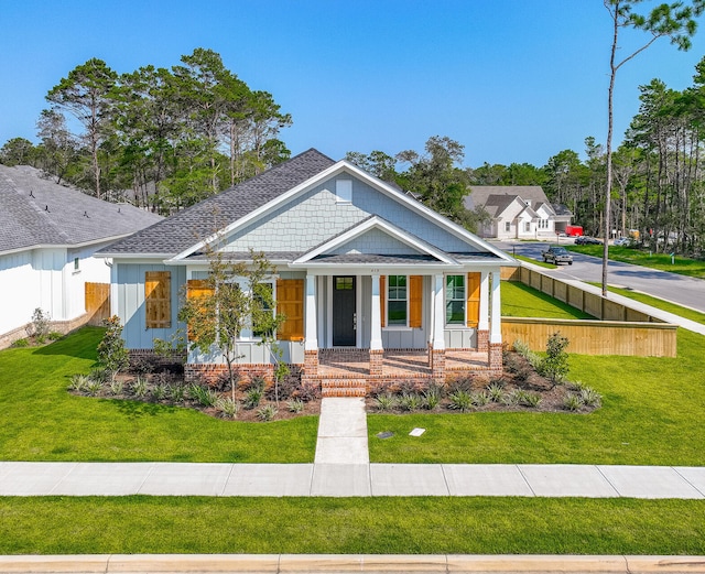 craftsman house with covered porch and a front yard