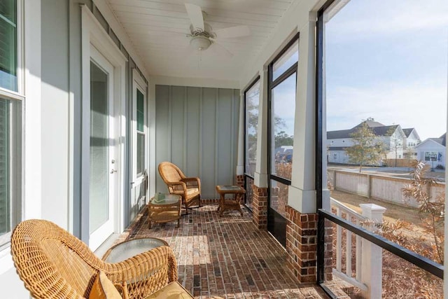 sunroom / solarium featuring ceiling fan