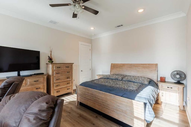 bedroom with ornamental molding, ceiling fan, and light wood-type flooring