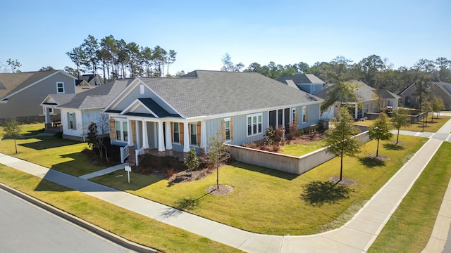 view of front of property with a residential view and a front lawn