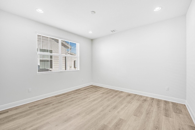 spare room with light hardwood / wood-style flooring