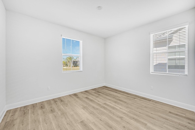 spare room featuring light wood-type flooring