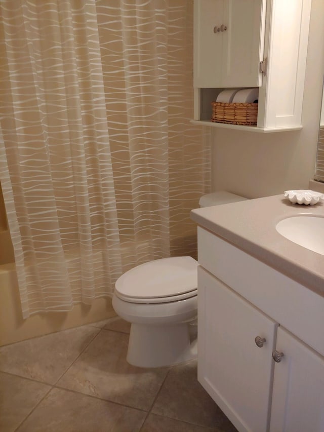 full bathroom featuring vanity, shower / tub combo, tile patterned floors, and toilet