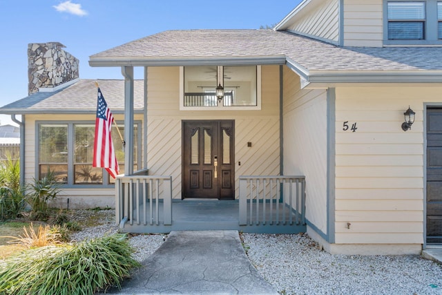 property entrance featuring a shingled roof, a porch, and a chimney