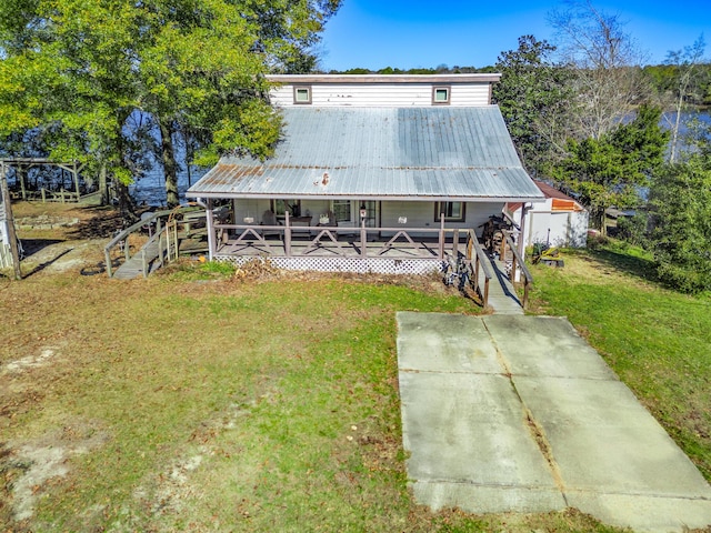 rear view of property with a yard