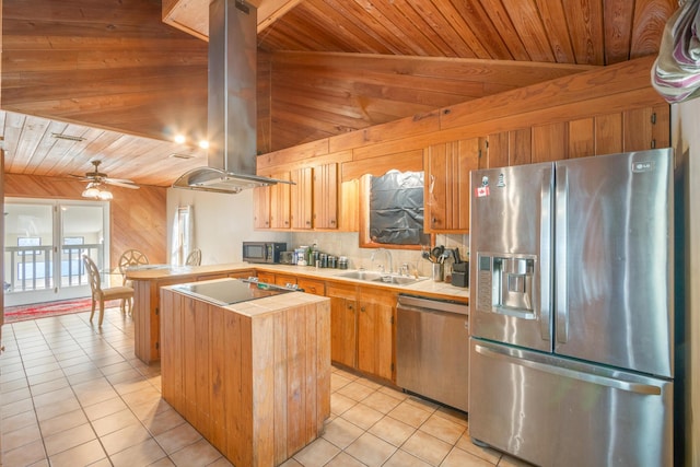 kitchen with stainless steel appliances, island exhaust hood, sink, and light tile patterned floors