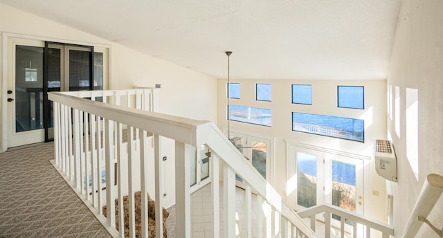 hall featuring lofted ceiling and carpet flooring