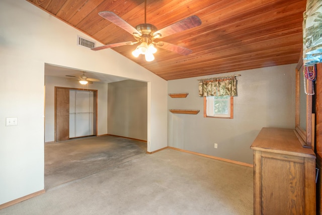 spare room featuring vaulted ceiling, light colored carpet, ceiling fan, and wood ceiling