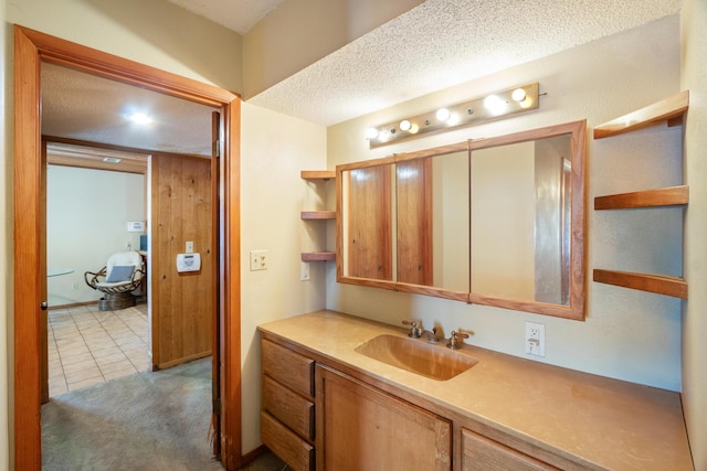 bathroom with vanity, tile patterned floors, and a textured ceiling