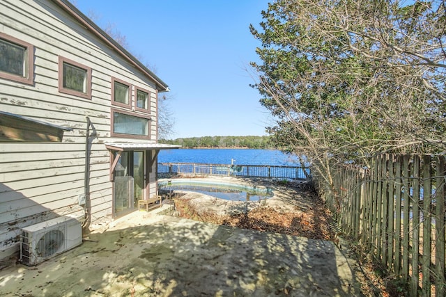 view of yard featuring ac unit, a patio, and a water view