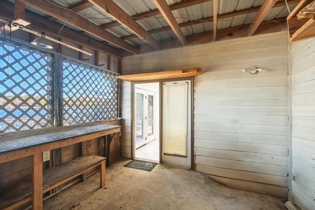 miscellaneous room featuring wood walls