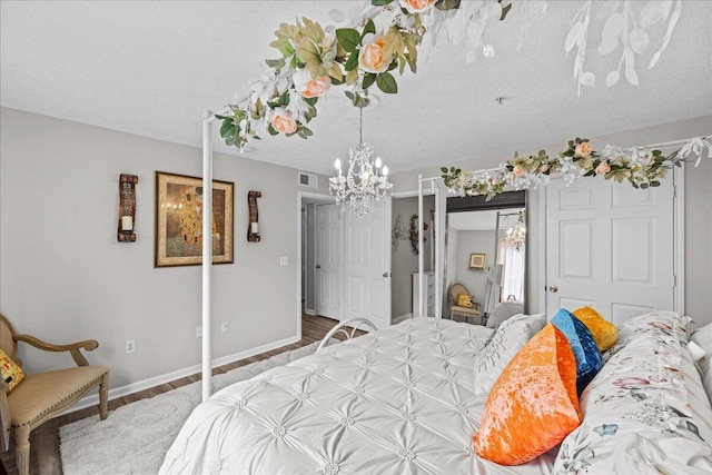 bedroom with hardwood / wood-style flooring and a textured ceiling