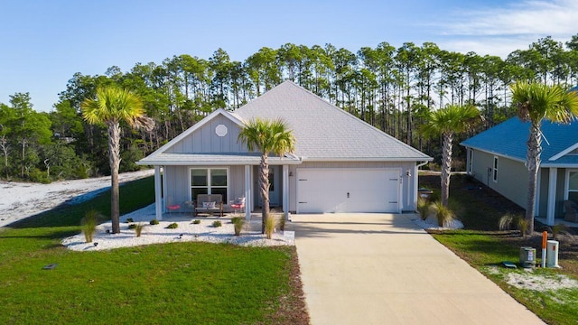 view of front of house with a garage, a front lawn, and a porch