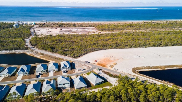 birds eye view of property featuring a beach view and a water view