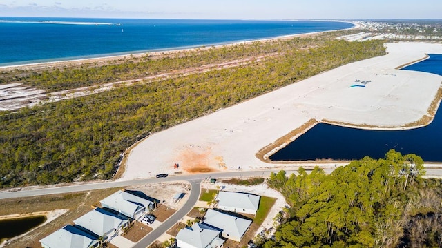 birds eye view of property featuring a water view and a beach view