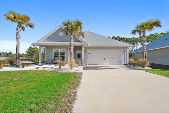 ranch-style house with a porch, a garage, and a front lawn