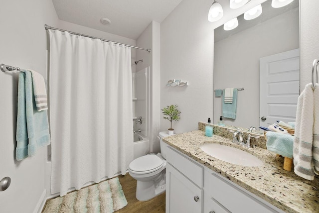 full bathroom featuring wood-type flooring, shower / tub combo with curtain, vanity, and toilet