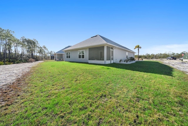 view of property exterior with a sunroom and a yard