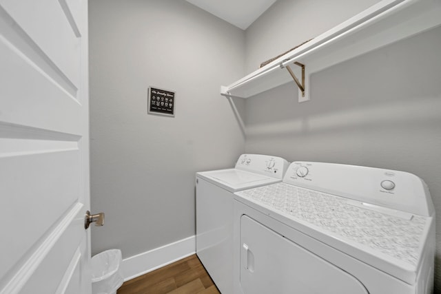 washroom featuring hardwood / wood-style flooring and washer and dryer