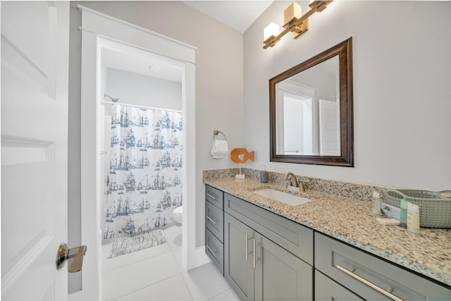 bathroom with tile patterned flooring, vanity, a shower with curtain, and toilet