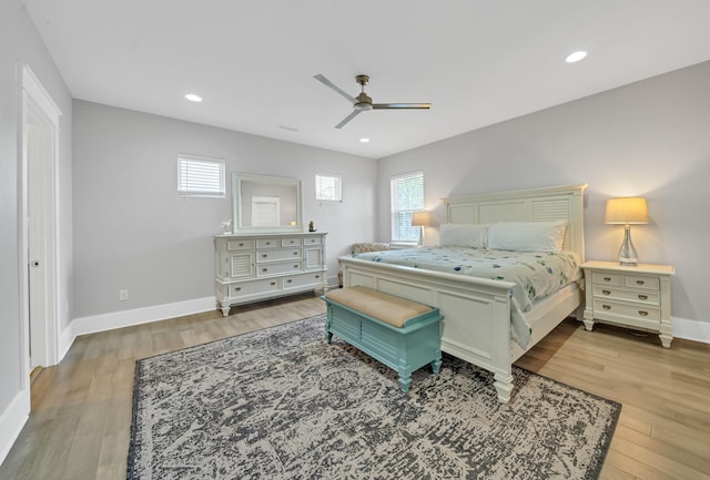 bedroom with multiple windows, light wood-type flooring, and ceiling fan