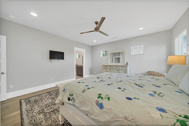 bedroom featuring ceiling fan, hardwood / wood-style floors, and ensuite bath