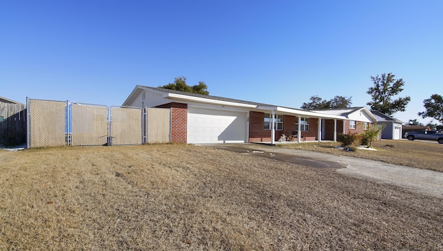 ranch-style house featuring a garage and a front lawn