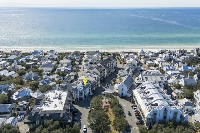 drone / aerial view with a beach view and a water view