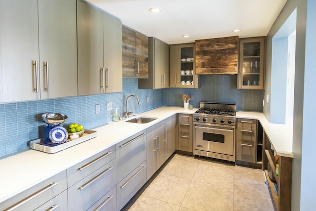 kitchen with sink, luxury stove, decorative backsplash, and light tile patterned floors