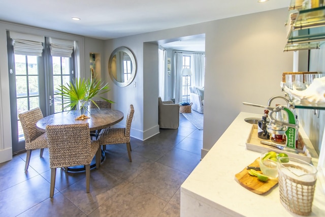 tiled dining room with a healthy amount of sunlight