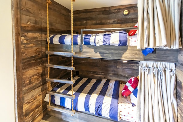 bedroom with wood walls