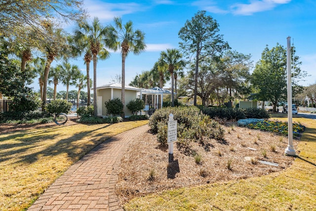 view of front facade with a pergola and a front yard