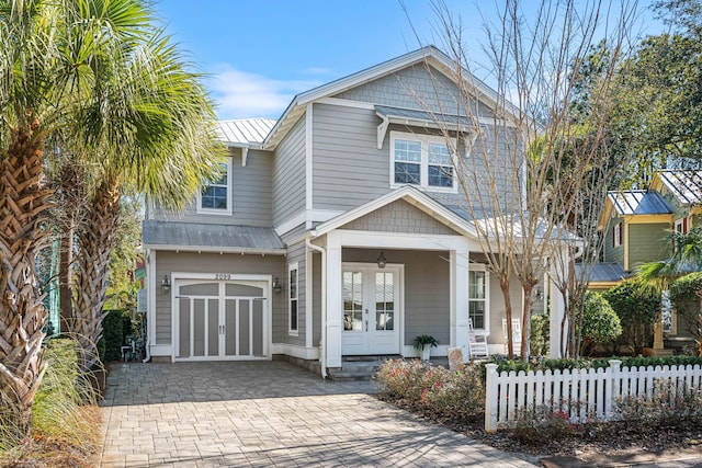 view of front of home with a garage and french doors