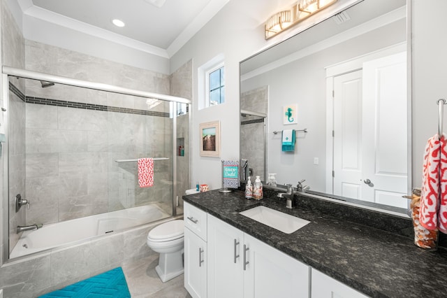 full bathroom featuring shower / bath combination with glass door, tile patterned flooring, vanity, toilet, and crown molding