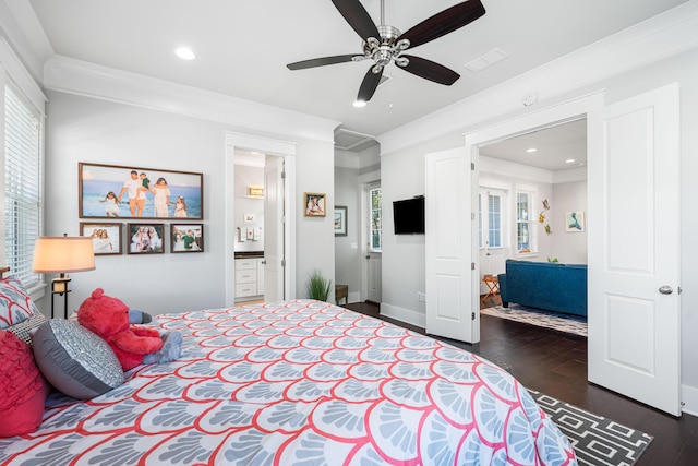 bedroom featuring ceiling fan, ensuite bath, ornamental molding, and dark hardwood / wood-style floors