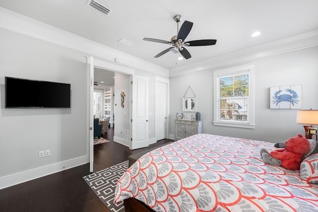 bedroom with ceiling fan, ornamental molding, and dark hardwood / wood-style floors