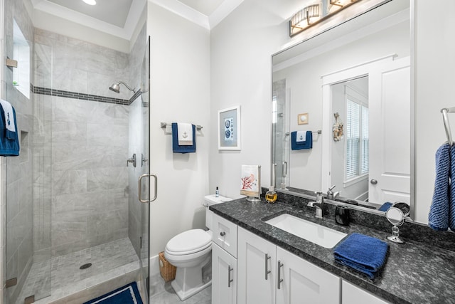 bathroom featuring vanity, crown molding, a shower with shower door, and toilet