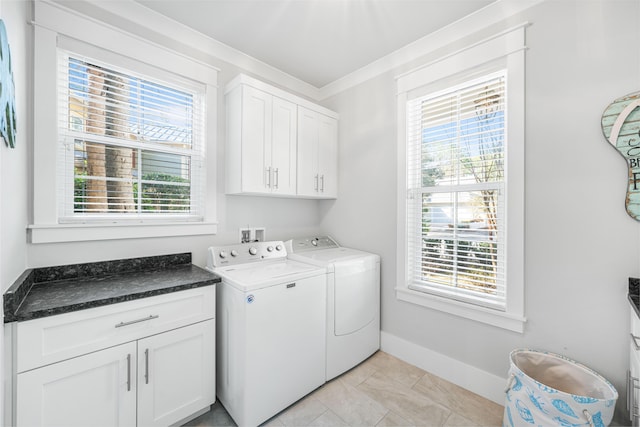 laundry room featuring cabinets, crown molding, separate washer and dryer, and a wealth of natural light