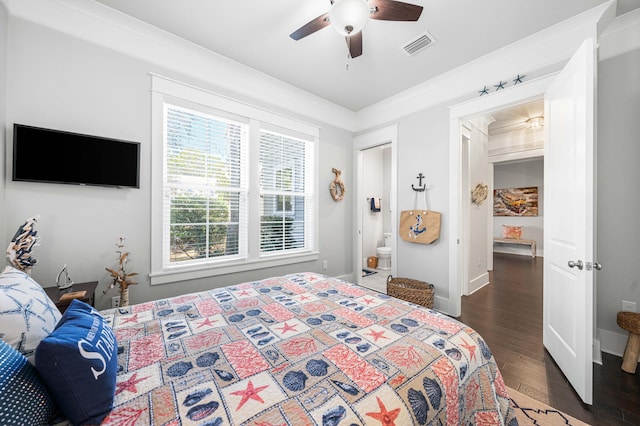 bedroom featuring connected bathroom, ornamental molding, dark hardwood / wood-style floors, and ceiling fan