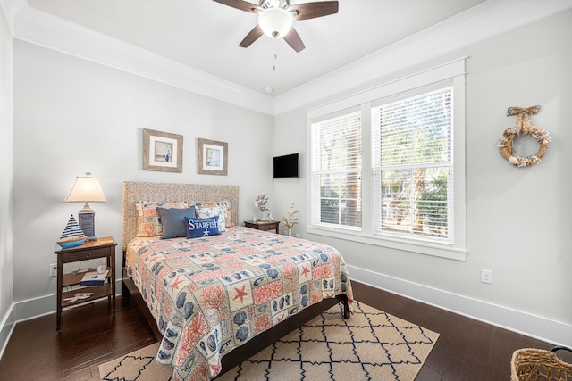 bedroom with ornamental molding, ceiling fan, and dark hardwood / wood-style flooring