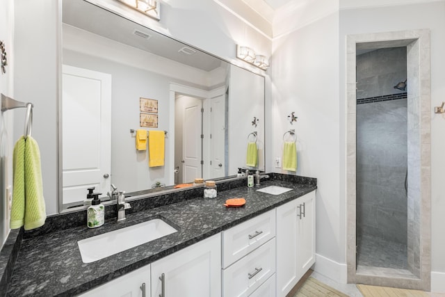 bathroom featuring vanity and a tile shower