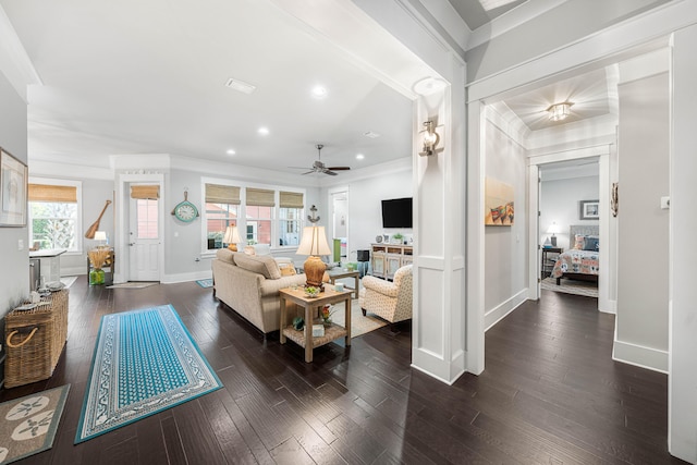 living room with ceiling fan, ornamental molding, and dark hardwood / wood-style flooring