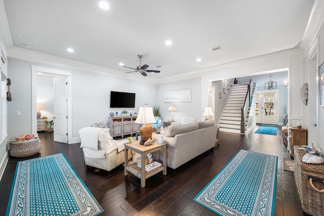 living room with dark hardwood / wood-style flooring, ornamental molding, and ceiling fan