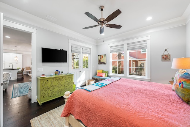 bedroom with ornamental molding, sink, ceiling fan, and dark hardwood / wood-style flooring